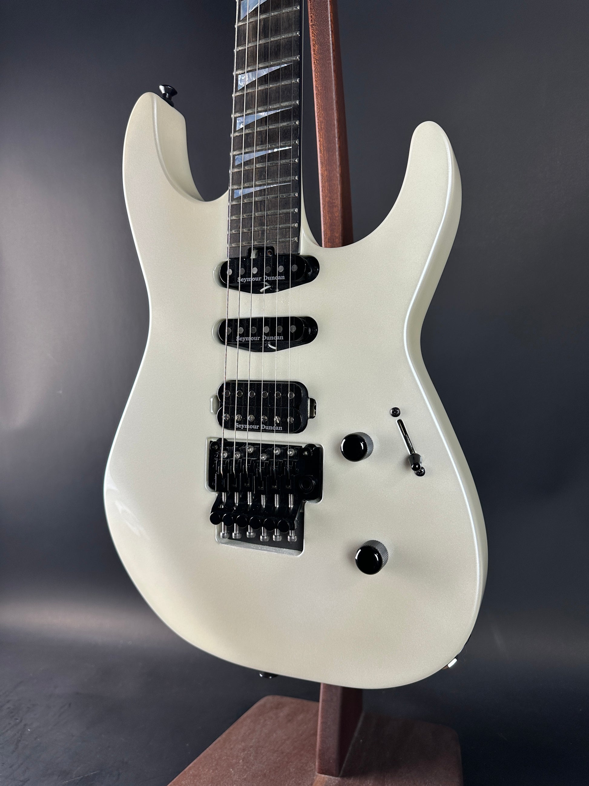 White electric guitar on a dark background