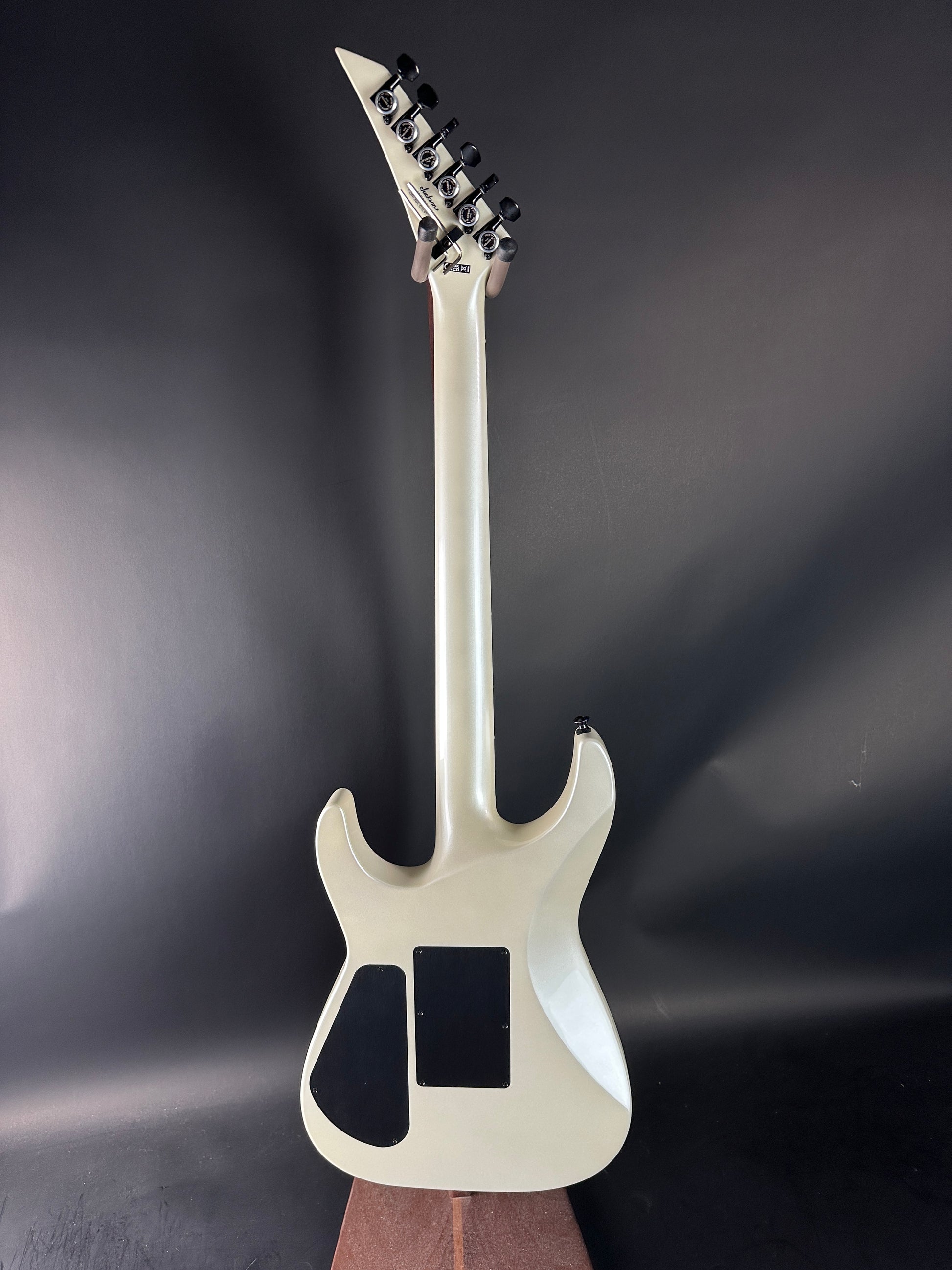 White electric guitar on a dark gray background