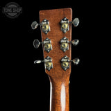 Close-up of the headstock of a guitar, showing six tuning pegs with gold and silver hardware on a black background. A Tone Shop watermark is visible in the top left corner.