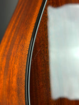 Close-up of a glossy dark brown wooden surface with visible wood grain and a thin dark edge trim.