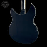 Close-up of the glossy dark blue back of an electric guitar against a black background, with a Tone Shop watermark in the upper left corner.