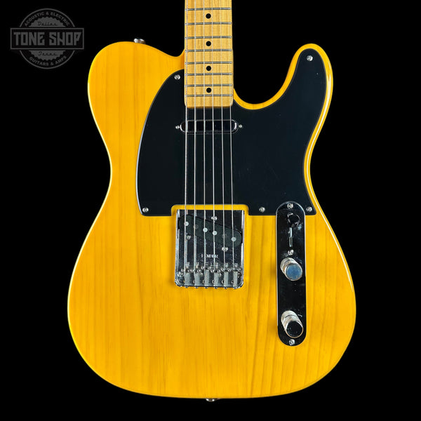 Yellow electric guitar with a black pickguard on a black background, featuring 'Tone Shop' logo.