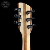 Close-up of a guitar headstock with a natural wood grain finish and black tuning pegs, shown against a solid black background. A Tone Shop watermark is visible in the top left corner.