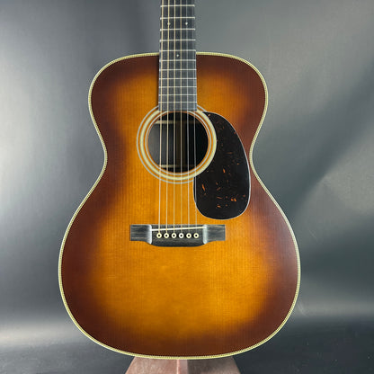 Acoustic guitar with a sunburst finish on a gray background