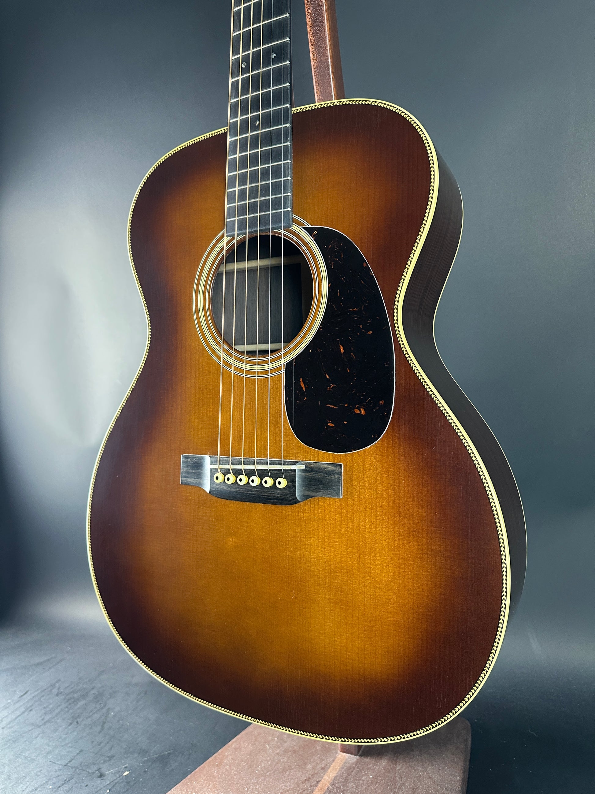 Acoustic guitar with a sunburst finish on a dark background