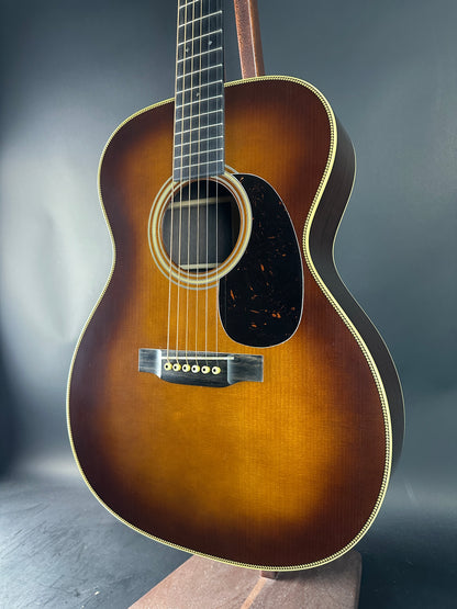 Acoustic guitar with a sunburst finish on a dark background