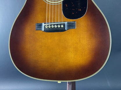 Close-up of an acoustic guitar's soundhole on a blue background