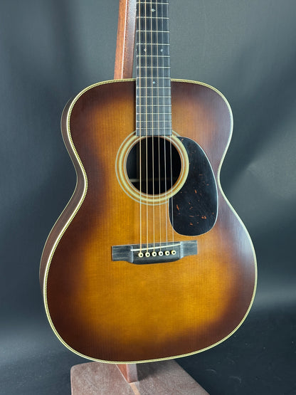 Acoustic guitar with a sunburst finish on a dark background