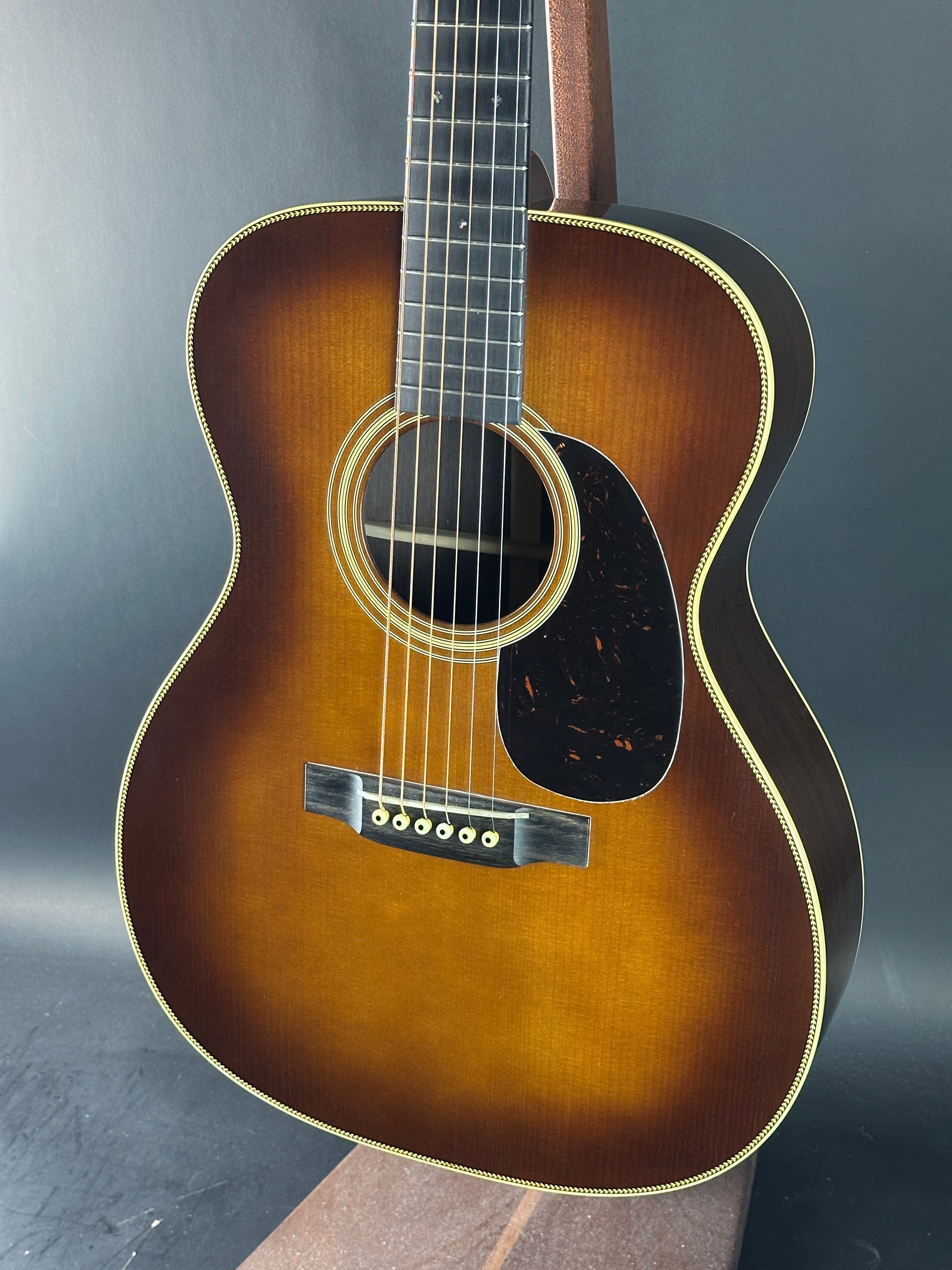 Acoustic guitar with a sunburst finish on a dark background