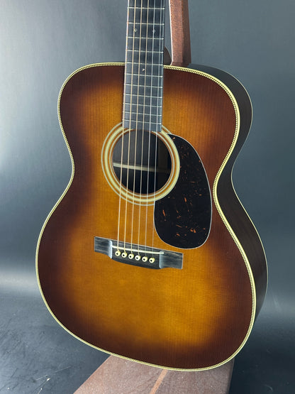 Acoustic guitar with a sunburst finish on a dark background