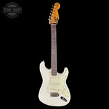 White electric guitar with a black background