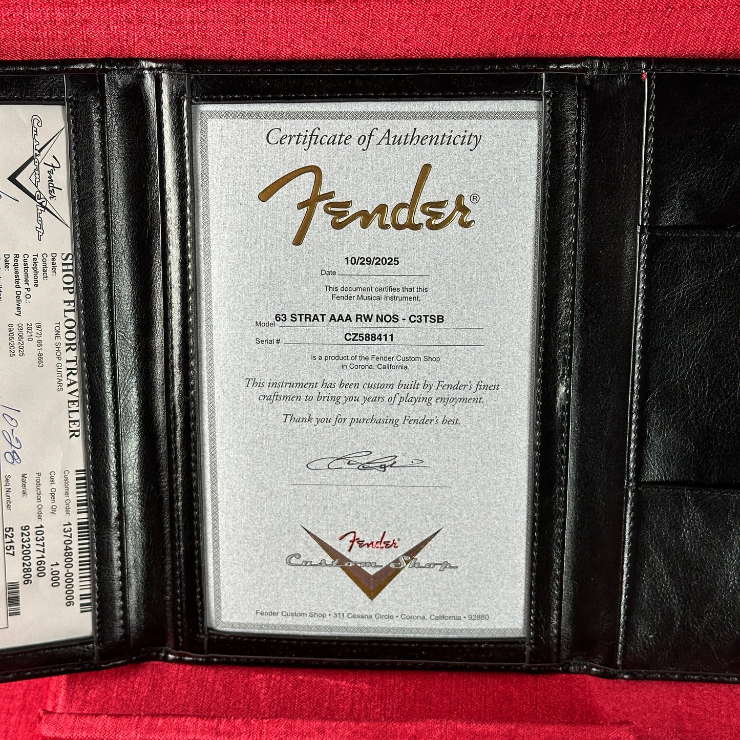 Fender certificate of authenticity in a black leather case on a red background