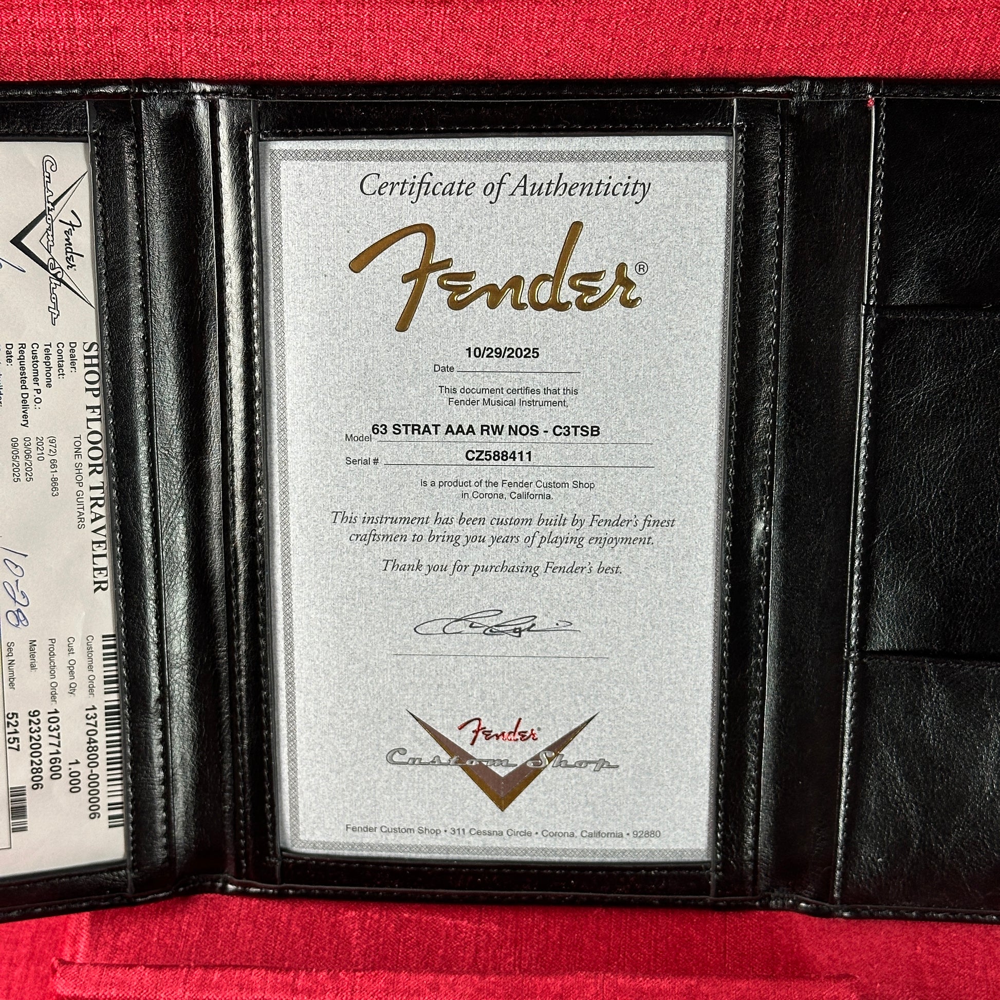 Fender certificate of authenticity in a black leather case on a red background