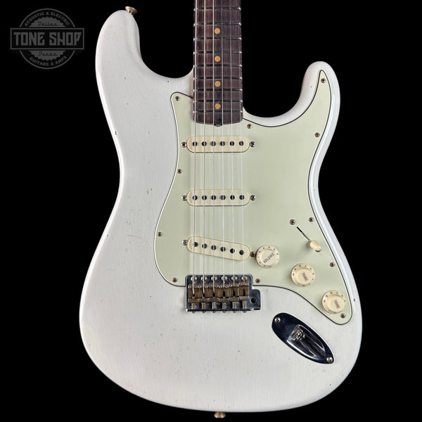 White electric guitar with a 'Tone Shop' logo in the corner