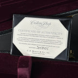 A black presentation box containing a white Certificate of Authenticity from Custom Shop and C.F.