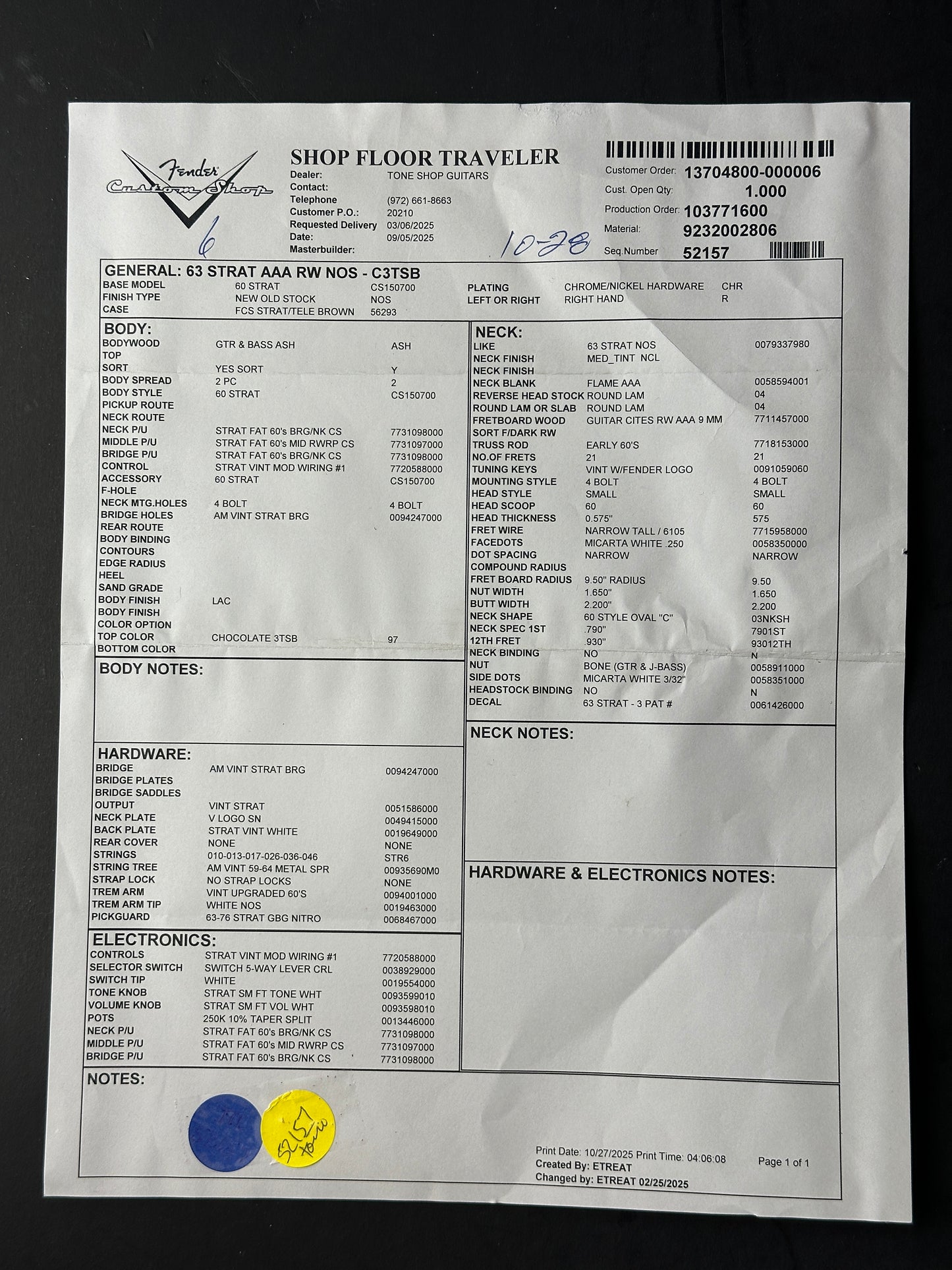 Sheet of paper with printed text and a few stickers on a dark background