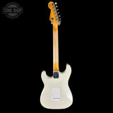 White electric guitar with a black background