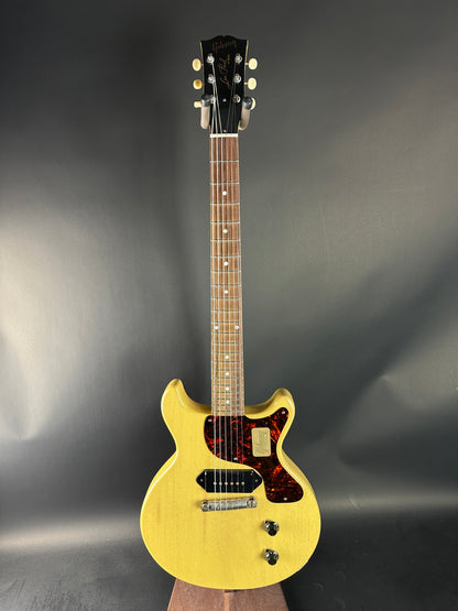 Yellow electric guitar on a dark gray background