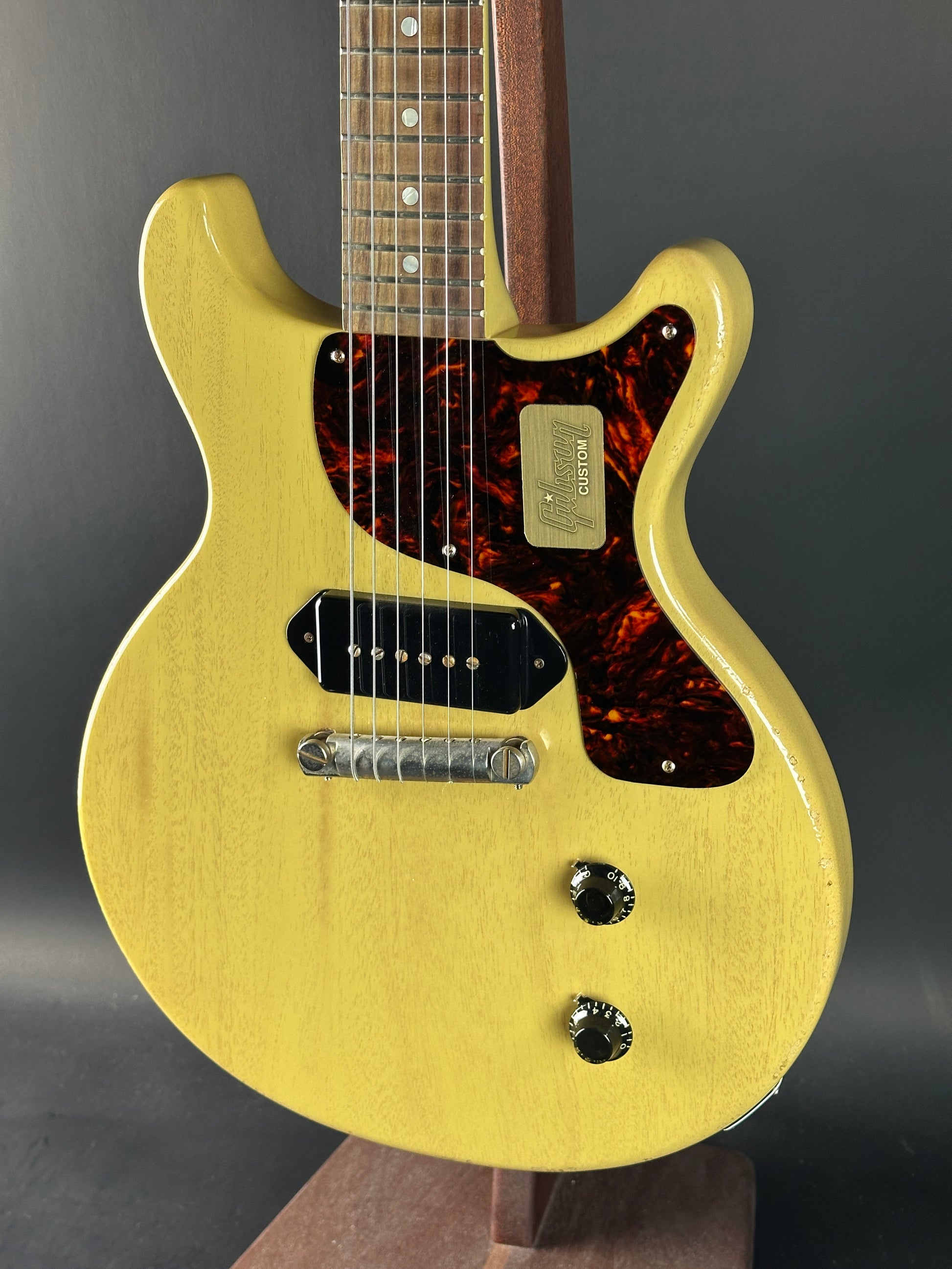 Electric guitar with yellow finish on a dark background