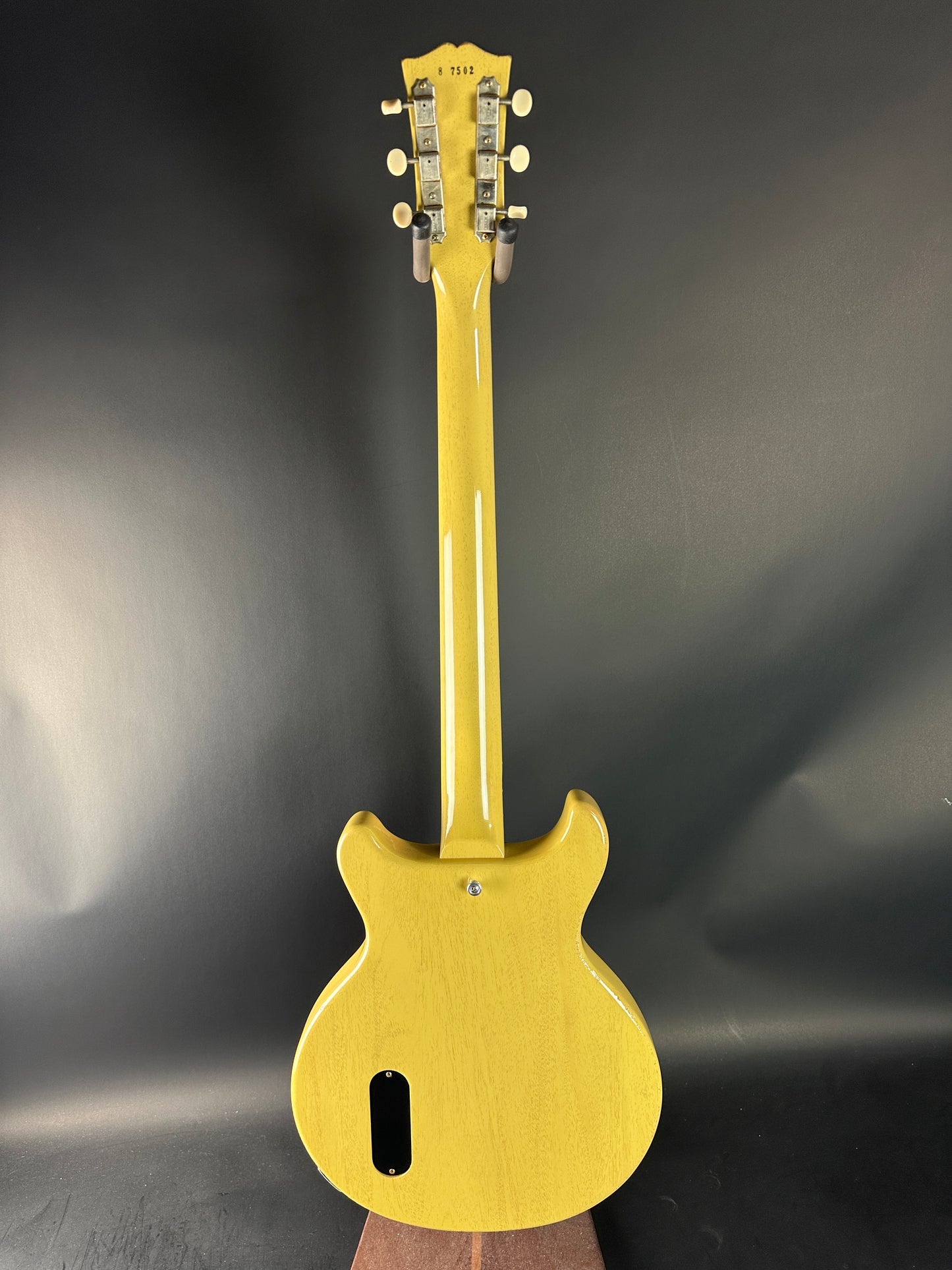 Gold electric guitar on a dark gray background