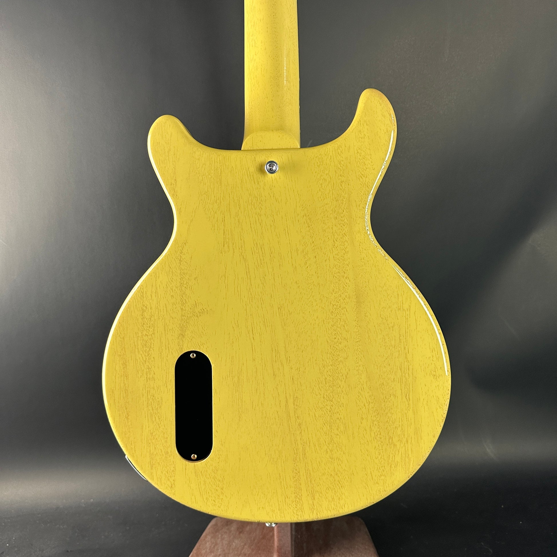 Yellow electric guitar body on a dark background