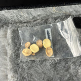 Clear plastic bag with yellow objects on a textured surface