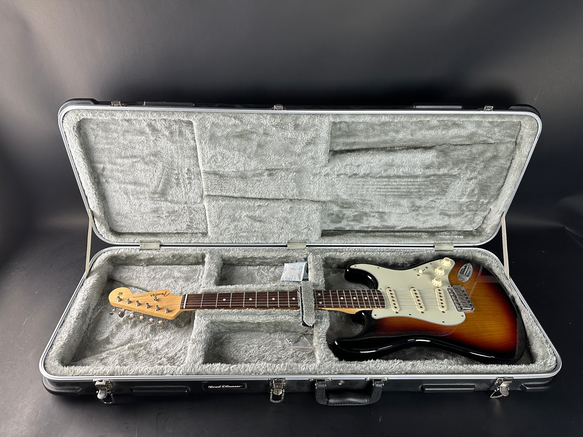 Electric guitar in a hard-shell case on a dark background