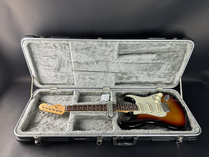 Electric guitar in a hard-shell case on a dark background