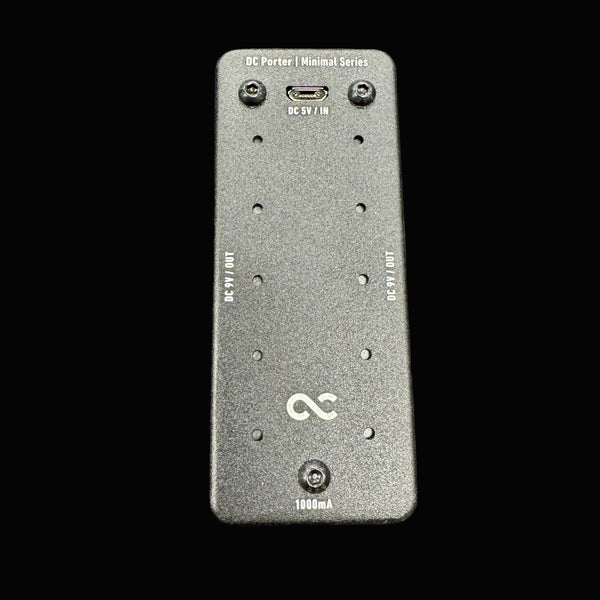 Black electronic device with ports on a gray textured background