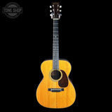 Acoustic guitar with a visible brand logo on a black background