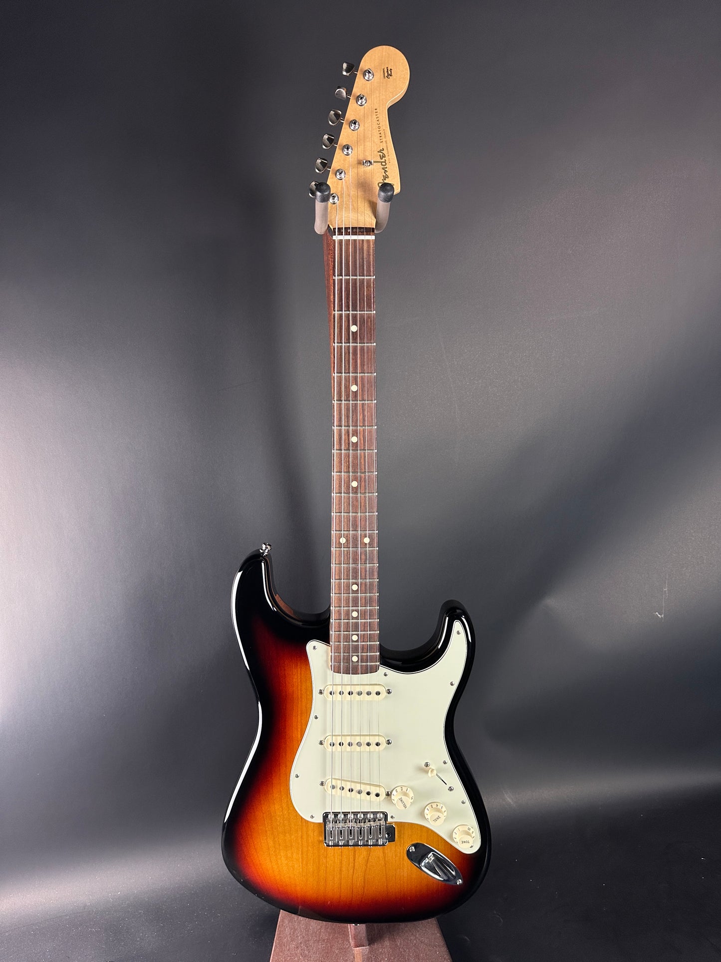 Electric guitar with a sunburst finish on a dark gray background