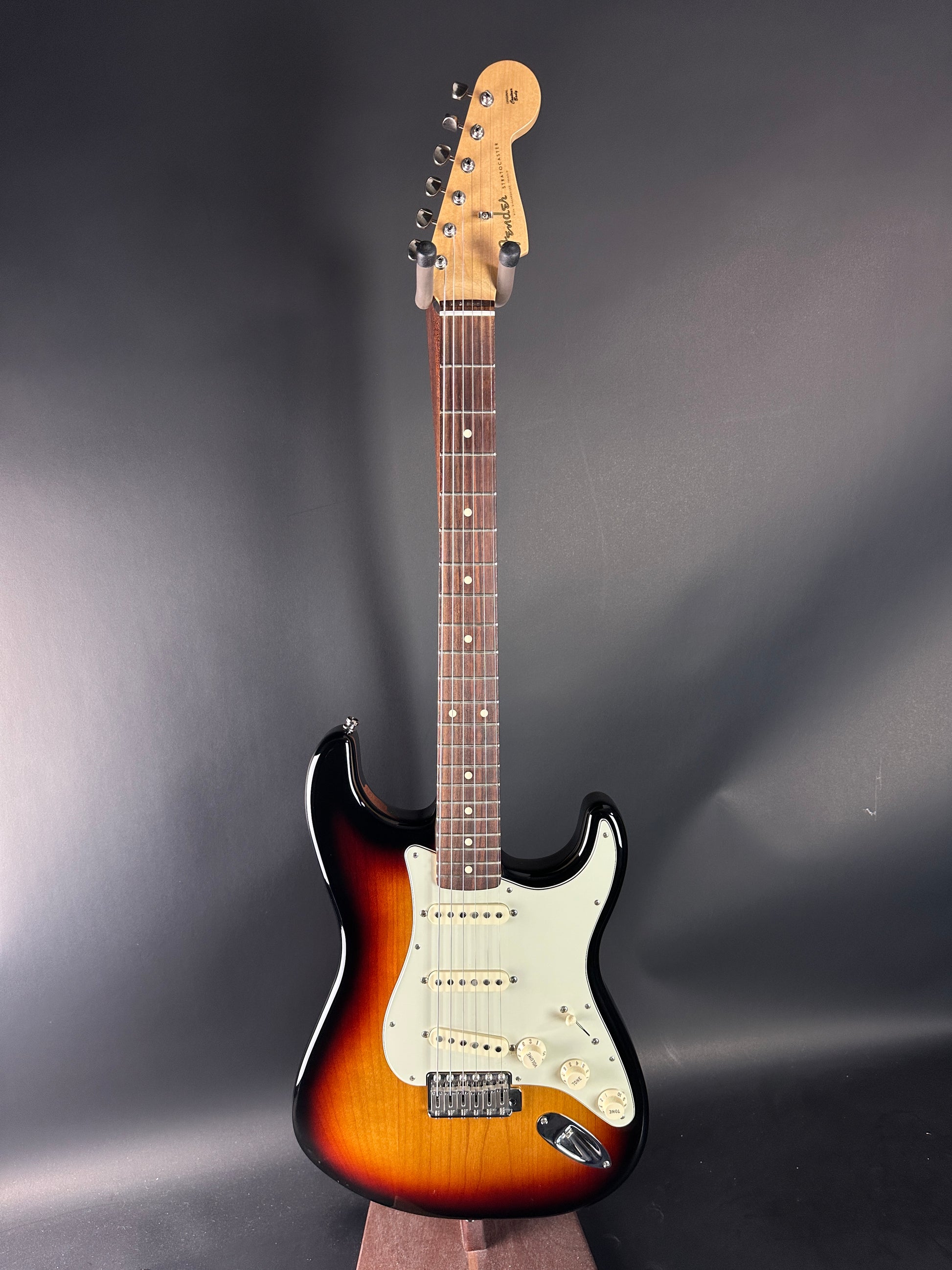 Electric guitar with a sunburst finish on a dark gray background
