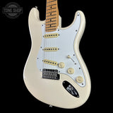 An electric guitar with a cream-colored body, a white pickguard, and a maple neck, shown against a solid black background. A Tone Shop watermark is visible in the top-left corner.