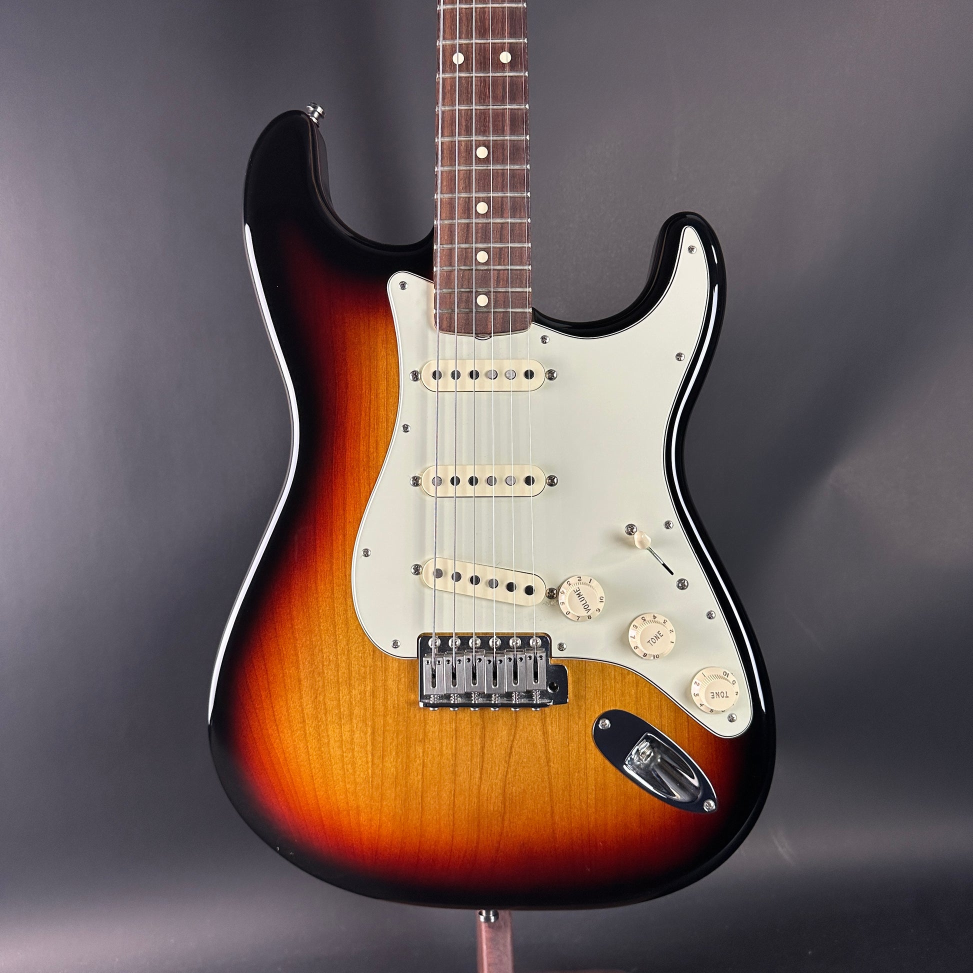 Electric guitar with a sunburst finish on a dark gray background