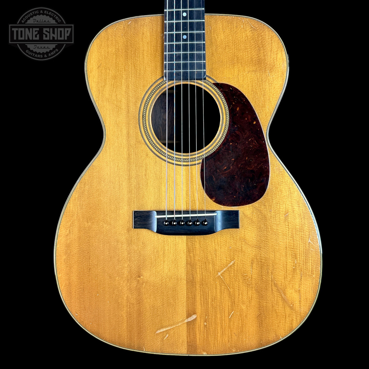 Acoustic guitar with a visible brand logo in the corner