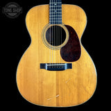 Acoustic guitar with a visible brand logo in the corner
