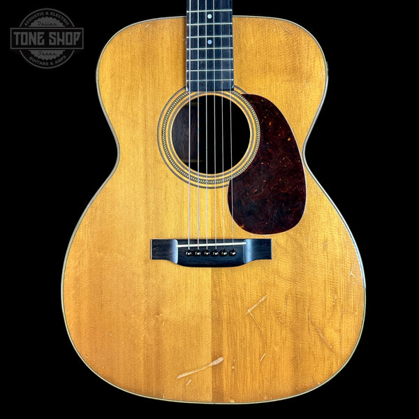 Acoustic guitar with a visible brand logo in the corner