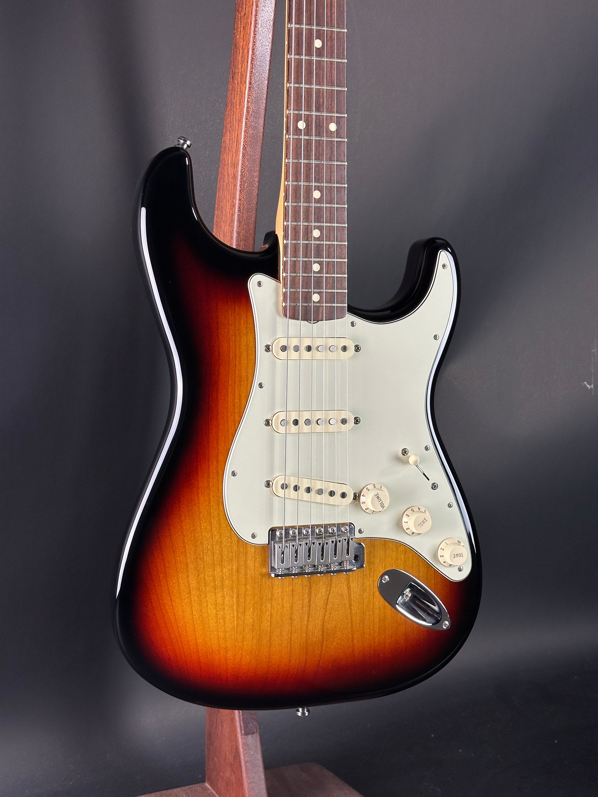 Electric guitar with a sunburst finish on a dark background