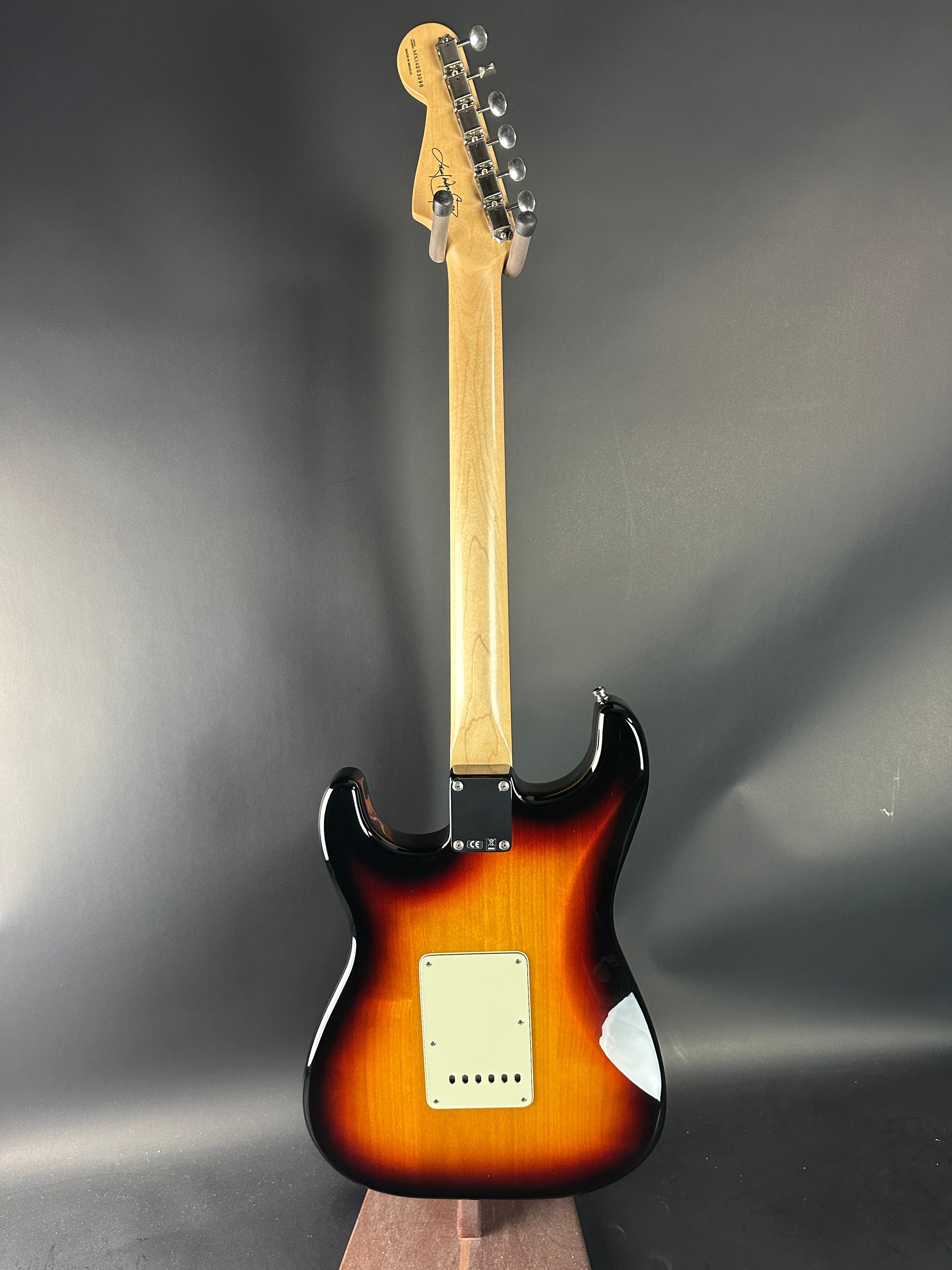 Fender Stratocaster guitar with sunburst finish on a gray background