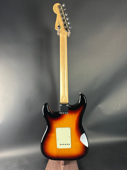Fender Stratocaster guitar with sunburst finish on a gray background
