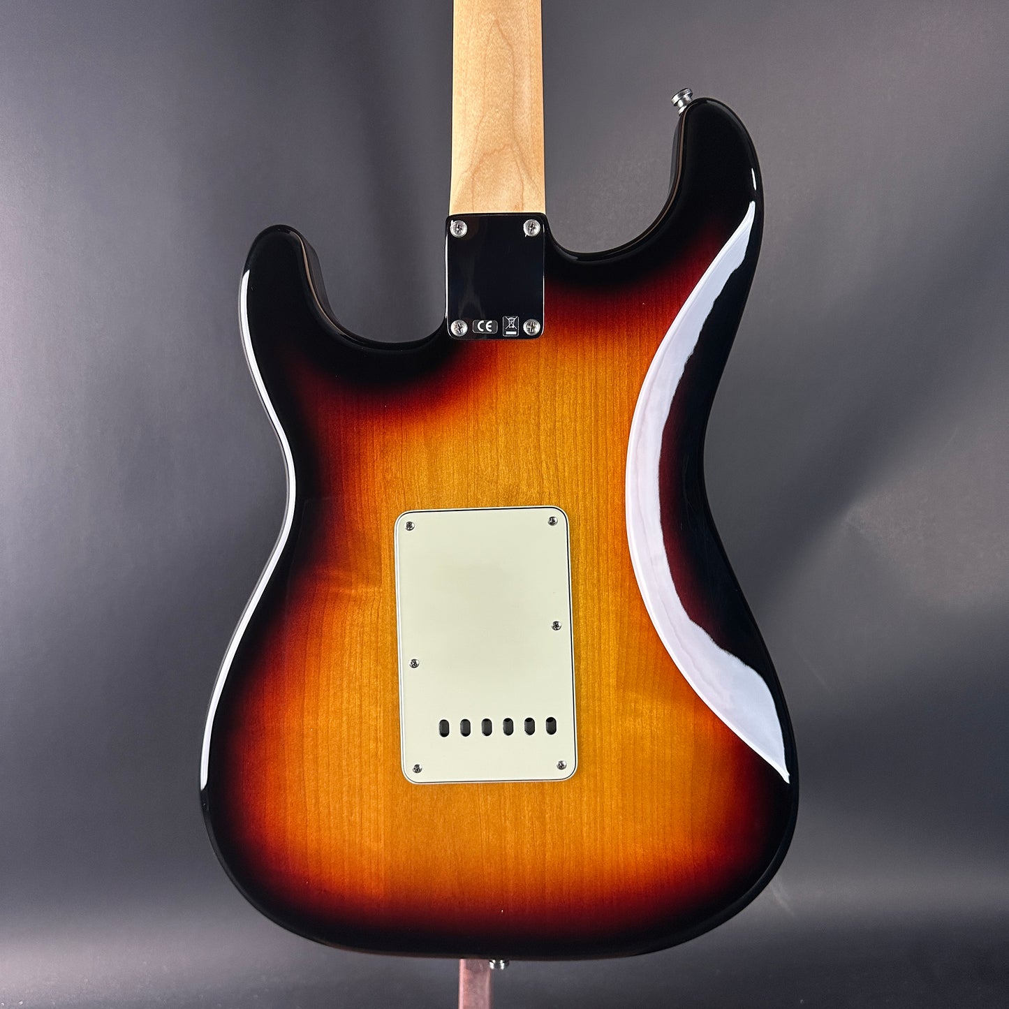 Electric guitar with a sunburst finish on a dark gray background