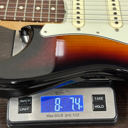 Guitar on a digital scale displaying weight
