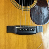 Close-up of an acoustic guitar's soundhole and bridge