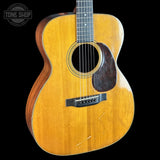 Acoustic guitar with a visible brand logo in the corner