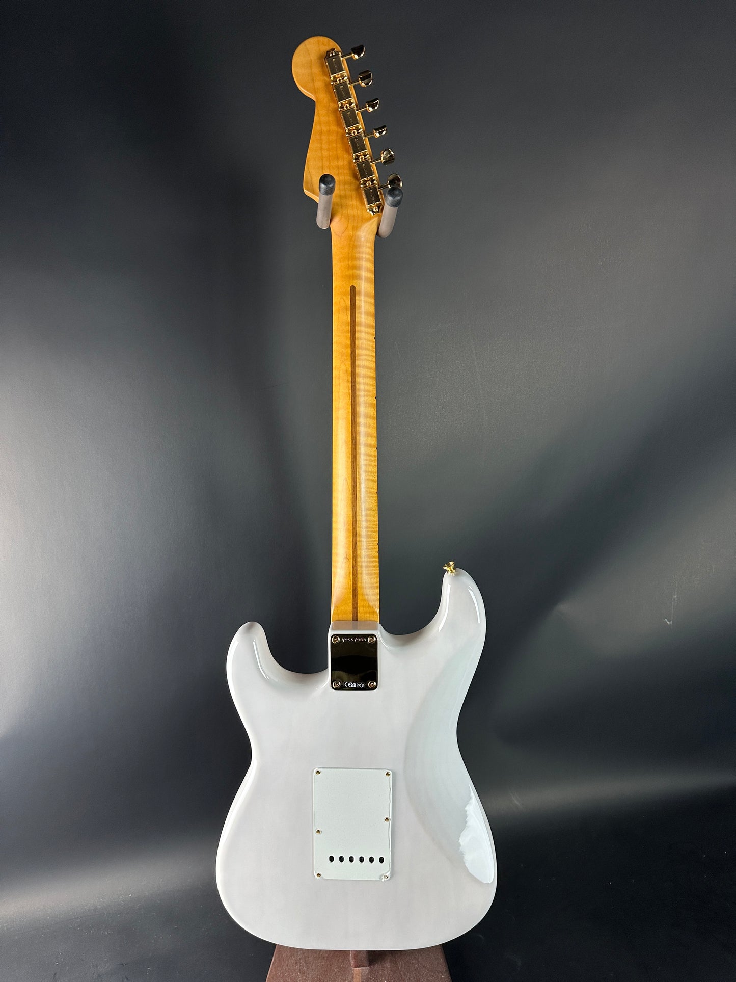 White electric guitar on a dark gray background