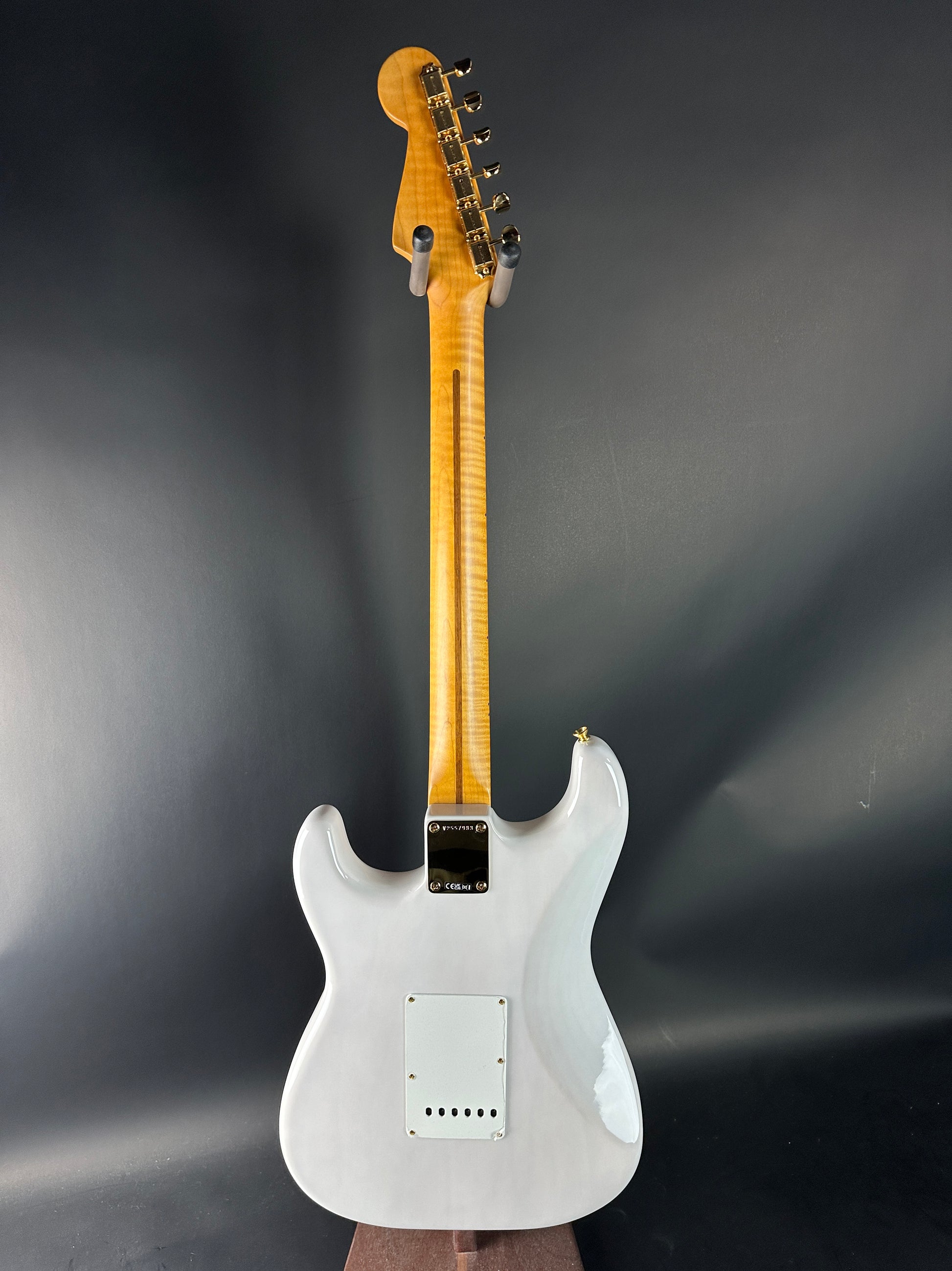 White electric guitar on a dark gray background