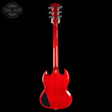 A glossy red electric guitar shown from the back against a solid black background, with a Tone Shop watermark in the upper left corner.