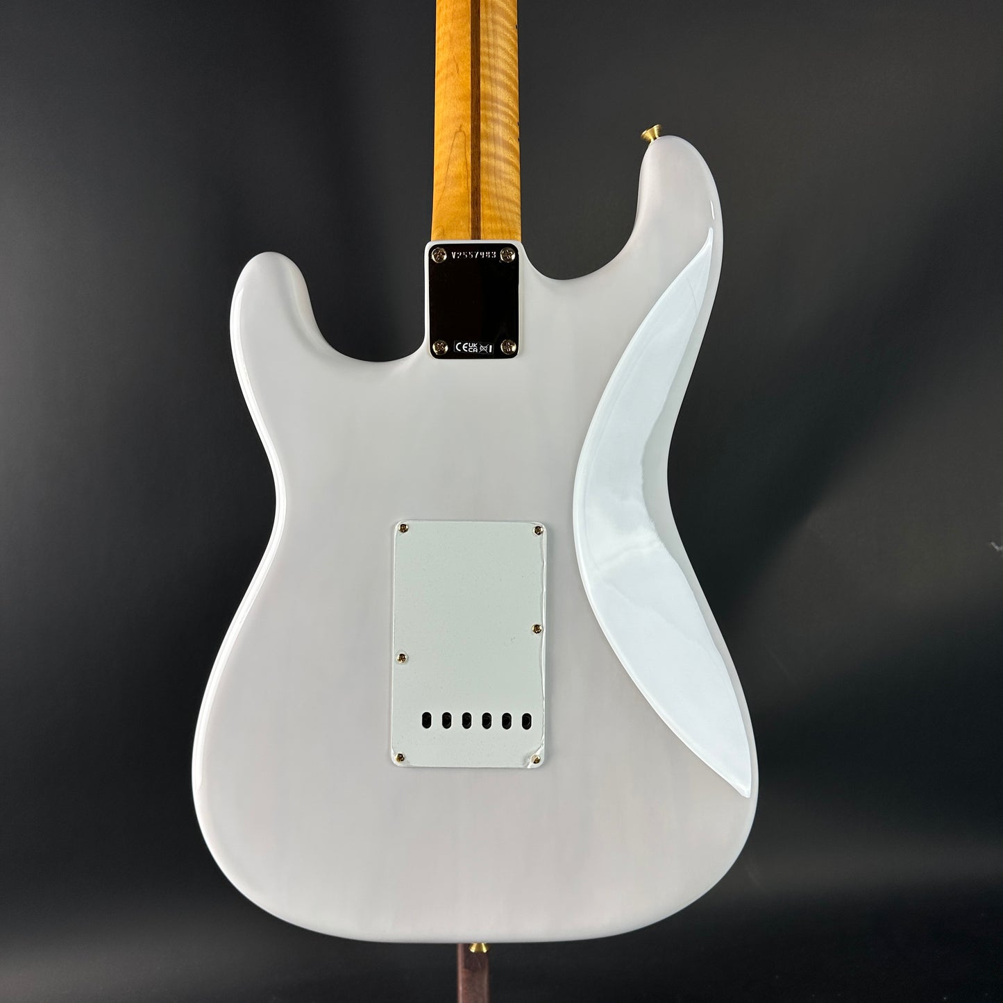 White electric guitar with a dark background