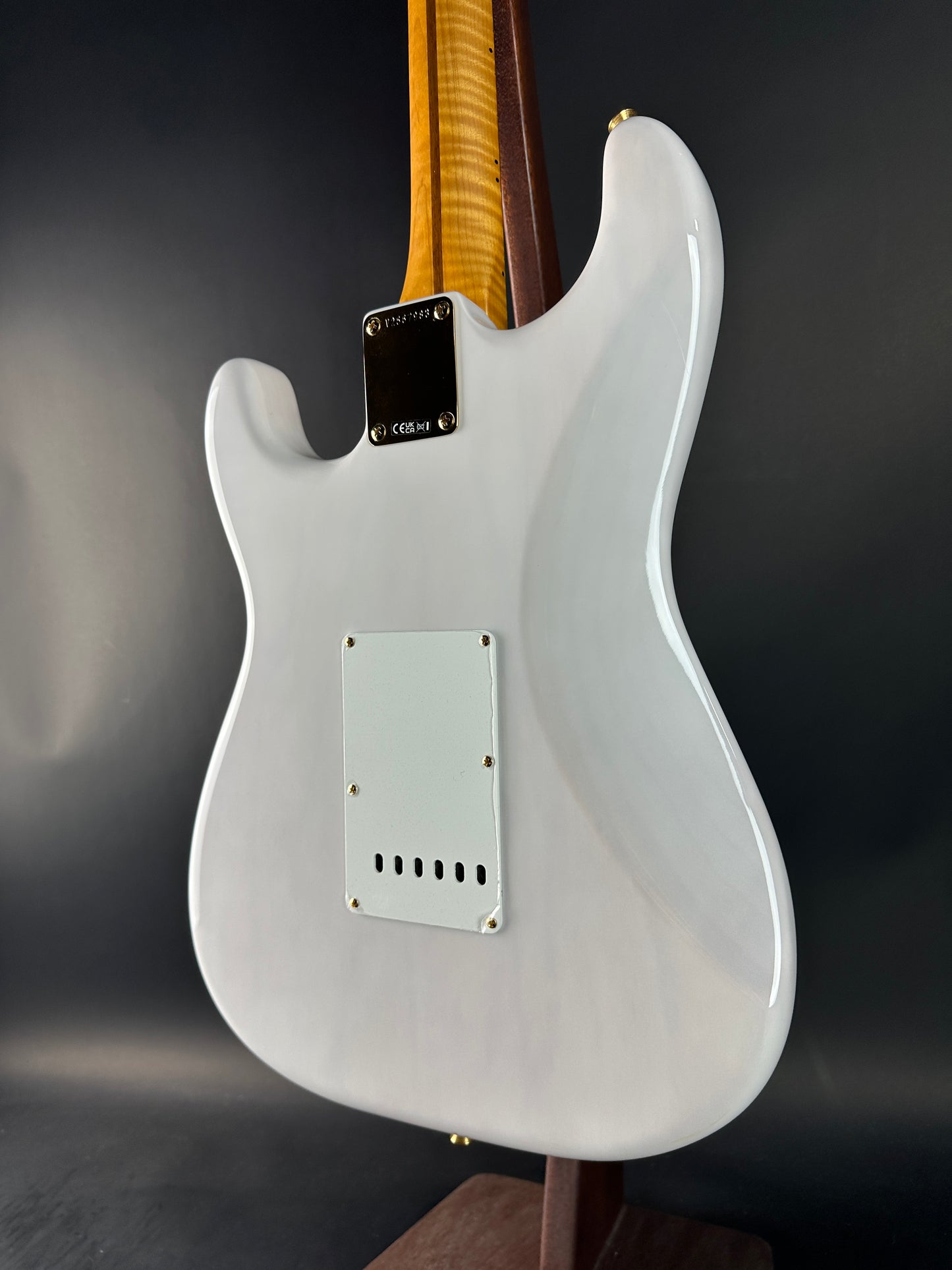 White electric guitar on a dark gray background