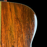 Close-up of a wooden guitar's soundboard with a black background